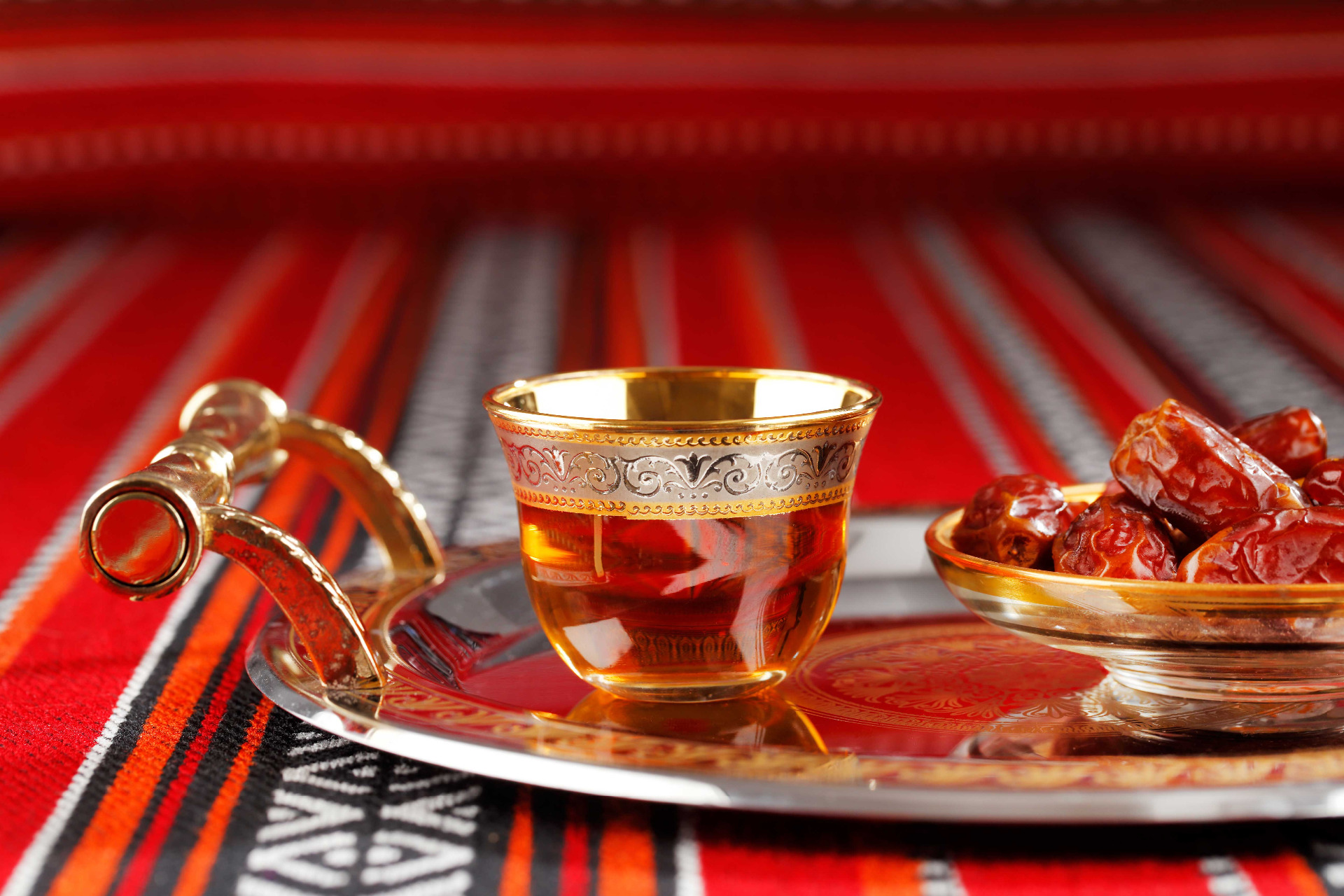 Arabic tea and dates on an ornate tray
