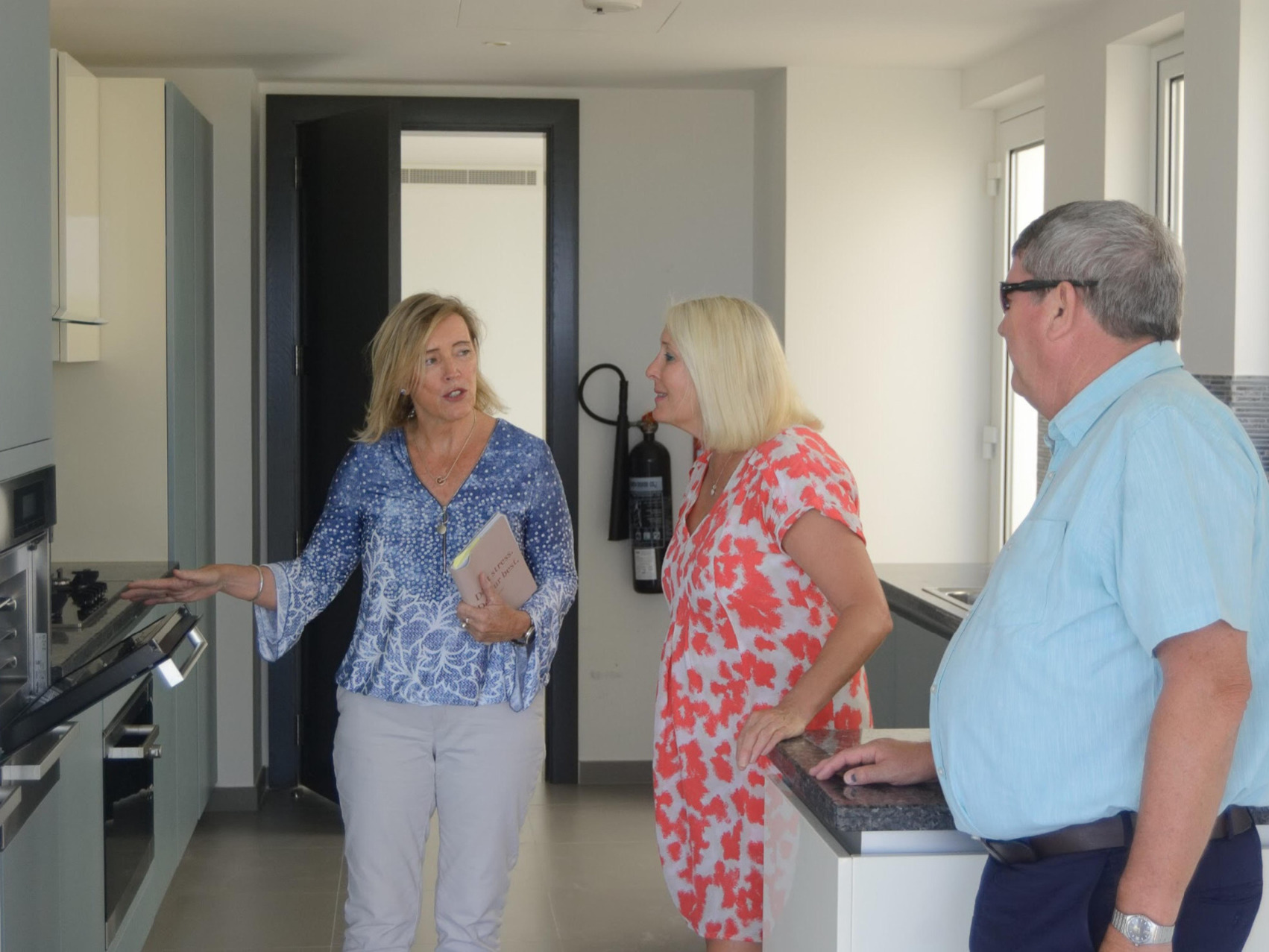 Dee Walker of Reloglobal helping a couple settle in their new apartment in Muscat Oman.